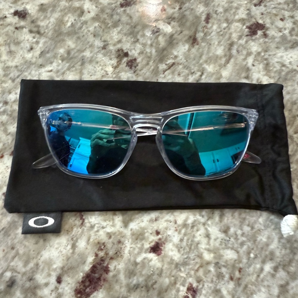 Oakley Manoburn Transparent Frame Sunglasses with Teal Lenses